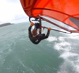 Windsurfer jumping in Daymer Bay Cornwall